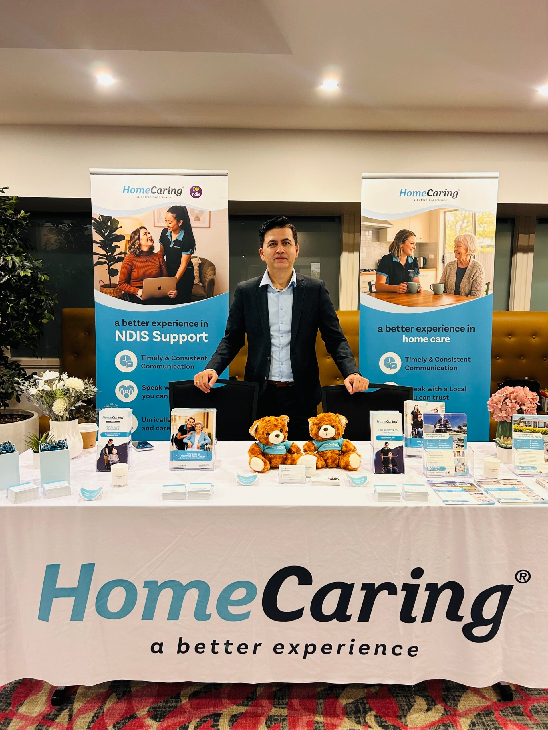 HomeCaring Sutherland director Harry Sigdel at a Home Care convention stand for HomeCaring